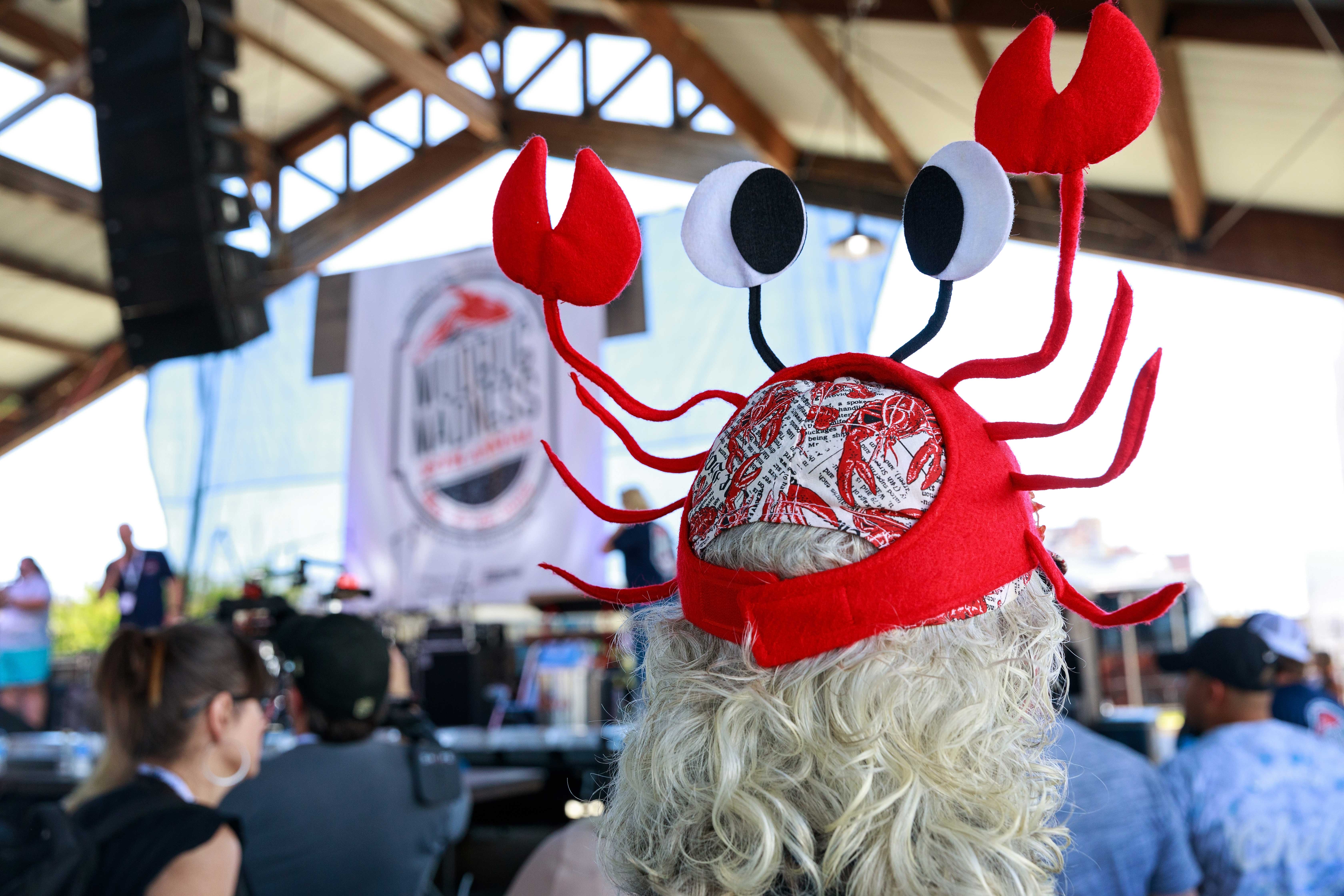 A woman wearing a fun crawfish hat at Shreveport Mudbug Madness Food Festivals 