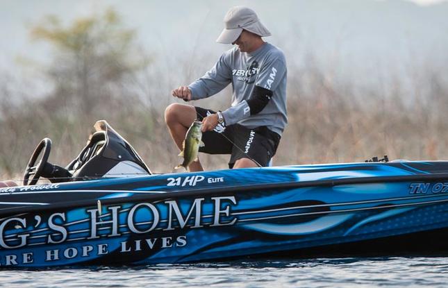 An angler unhooks his catch on Toledo Bend.
