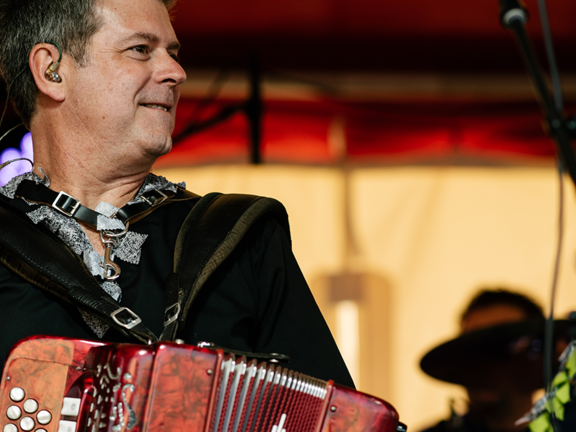 A male musician playing an instrument