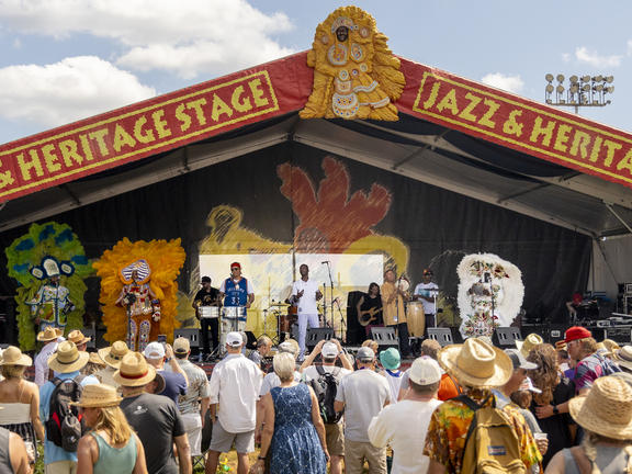 A hip hop ensemble takes the JazzFest main stage.