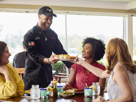 Happy people enjoying food at a Louisiana restaurant