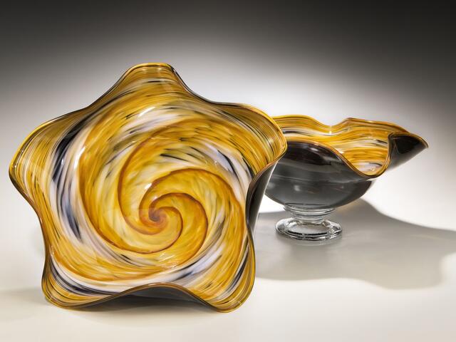 Amber, Black, and White Wavy Bowl amongst the unique artwork found at Rosetree Blown Glass Studio.
