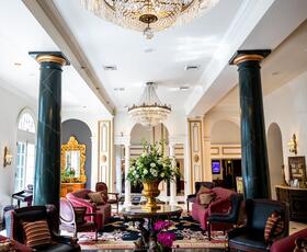 Interior view of the colorful lobby and chandelier at Bourbon Orleans Hotel in New Orleans.