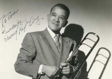 A signed portrait of Kid Ory holding a trombone
