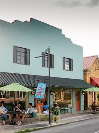 Colorful buildings line a Louisiana main street.